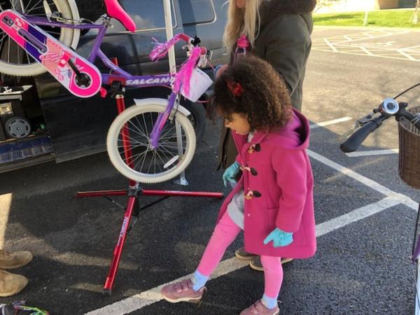 Child with a bicycle.