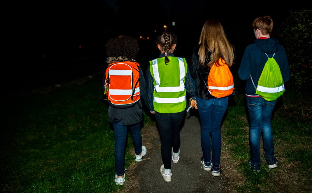 Kids with reflective bags and hivizes.