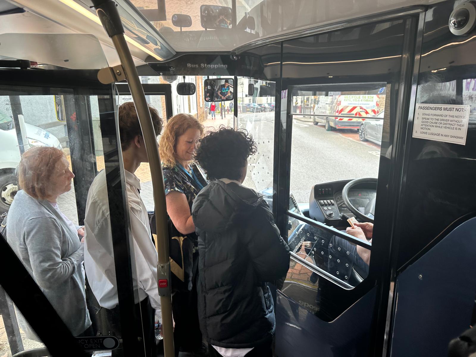 teens paying on bus.