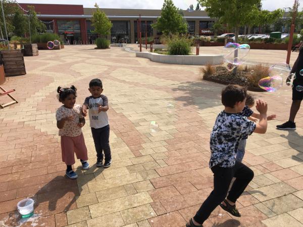 Kids playing with bubbles.