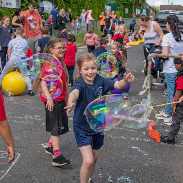 Kids playing with bubbles.