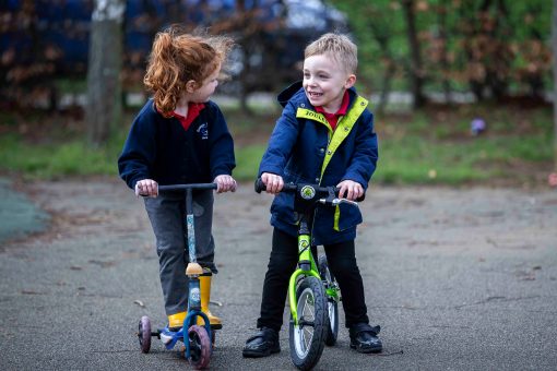 Nursery children on scooters.