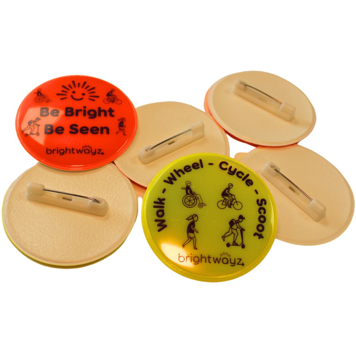 Be Bright Be Seen and Walk Wheel Cycle Scoot Badges showing pins.