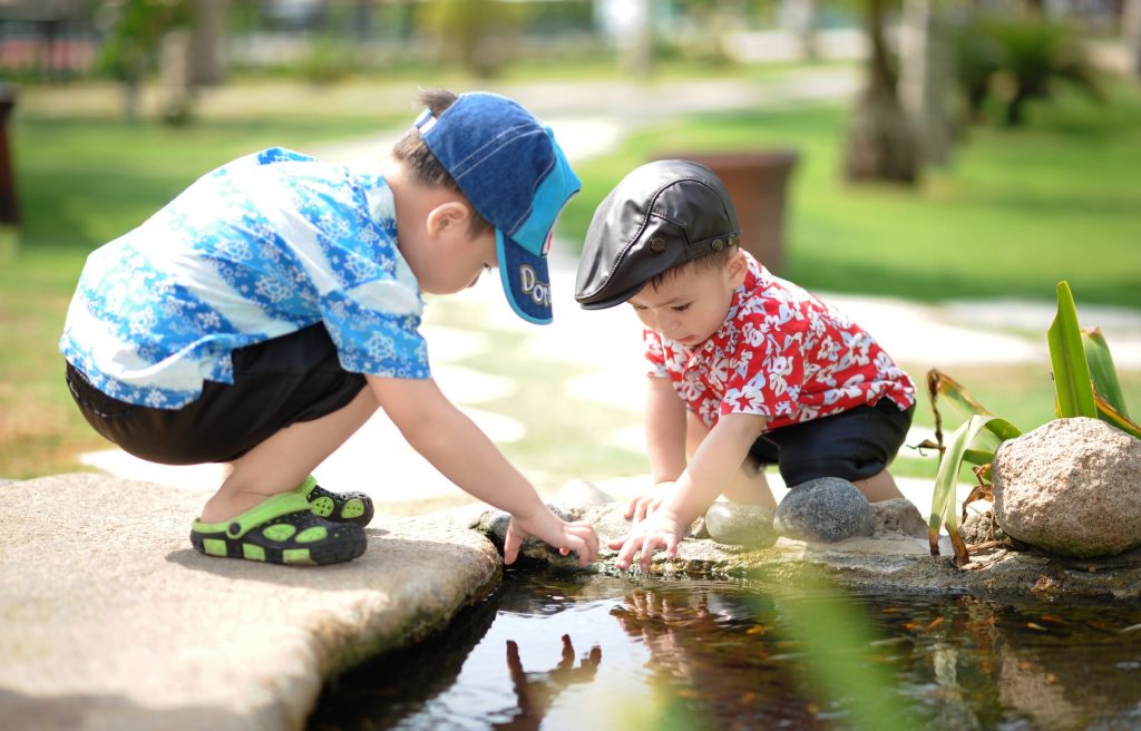 Two kids playing with water.