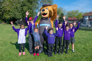 Wicky bear with schoolchildren.